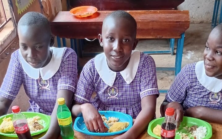 Children smiling during lunch at our school