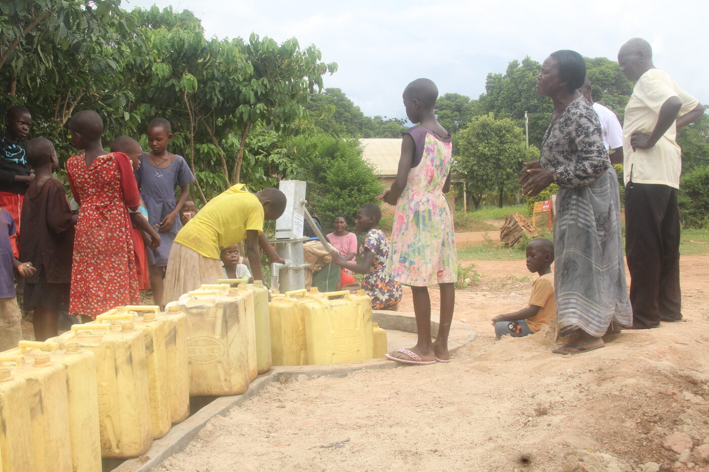 Families collecting clean water from borehole